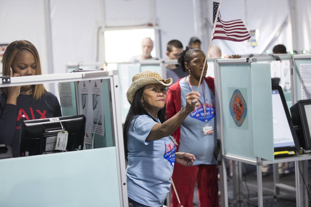 Volunteer Leah Barney, middle, directs voters to open machines at the voting station at 7881 W. Tropical Pkwy. on Tuesday, November 6, 2018, in Las Vegas. Benjamin Hager Las Vegas Review-Journal