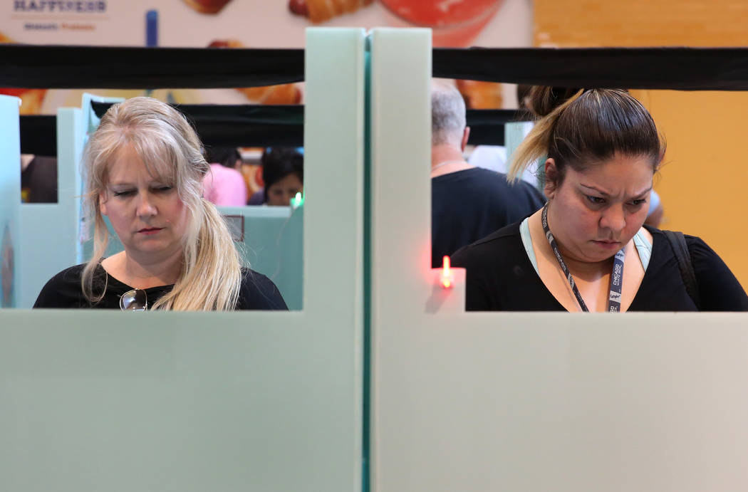 Voters, including Elisabeth Mendez, right, cast their ballots at a polling station at Galleria Mall on Tuesday, Nov. 6, 2018, in Henderson. (Bizuayehu Tesfaye/Las Vegas Review-Journal) @bizutesfaye