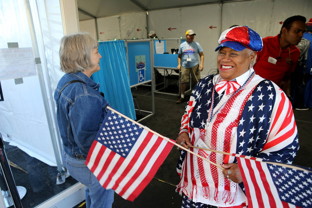 Poll worker Clarice Watkins manages the line just after opening the doors at 7 a.m. to the voting center at Downtown Summerlin in Las Vegas Tuesday, Nov. 6, 2018. K.M. Cannon Las Vegas Review-Jour ...