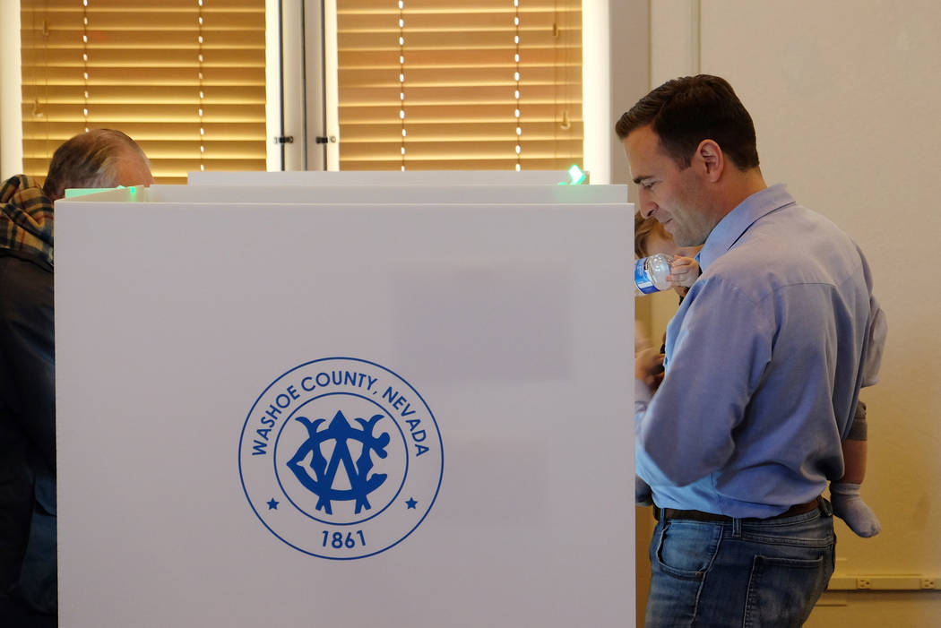 Adam Laxalt, Republican candidate for Nevada governor, holds his son, Jack, while voting at Bartley Ranch Regional Park in Reno, Tuesday, Nov. 6, 2018. (Bill Dentzer/Las Vegas Review-Journal)