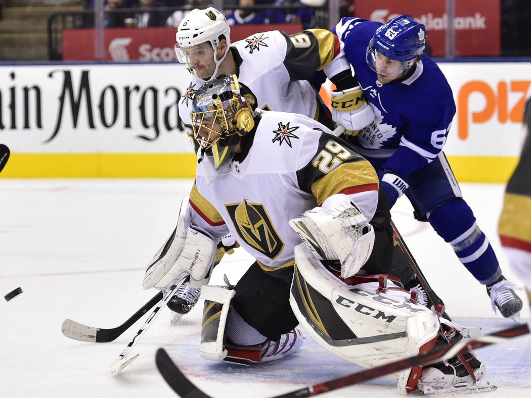Vegas Golden Knights goaltender Marc-Andre Fleury (29) and defendeman Colin Miller (6) and Toronto Maple Leafs left wing Tyler Ennis (63) watch the puck during the second period of an NHL hockey g ...