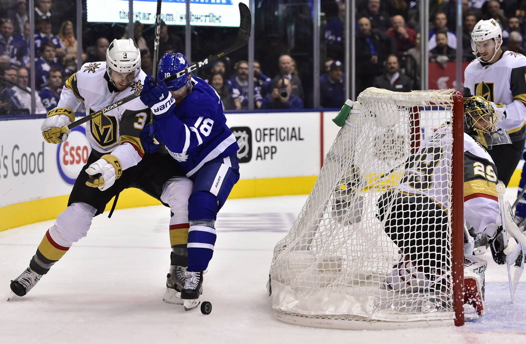 Vegas Golden Knights defenseman Brayden McNabb (3) works against Toronto Maple Leafs left wing Andreas Johnsson (18) behind the Vegas net during the first period of an NHL hockey game Tuesday, Nov ...