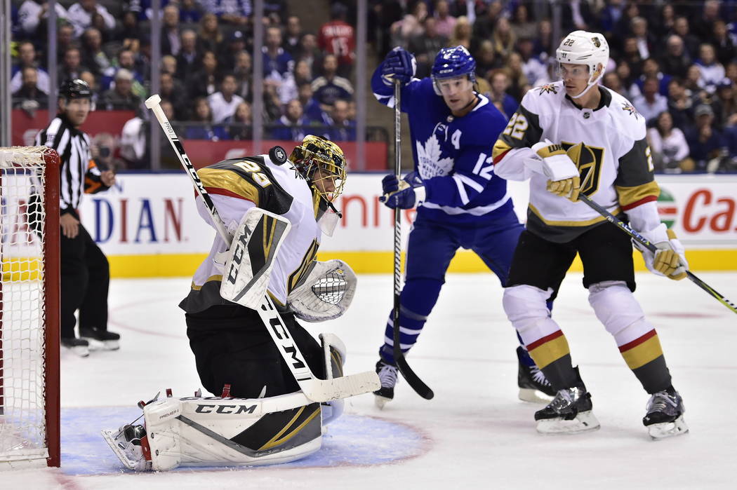 Vegas Golden Knights goaltender Marc-Andre Fleury (29) makes a save as Toronto Maple Leafs center Patrick Marleau (12) looks for a rebound and Golden Knights defenseman Nick Holden (22) defends du ...