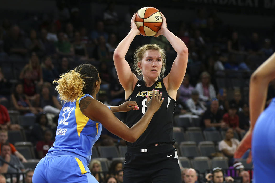 Las Vegas Aces center Carolyn Swords (8) looks to pass the ball in front of Chicago Sky forward Cheyenne Parker (32) during the second half of a WNBA basketball game at Mandalay Bay Events Center ...