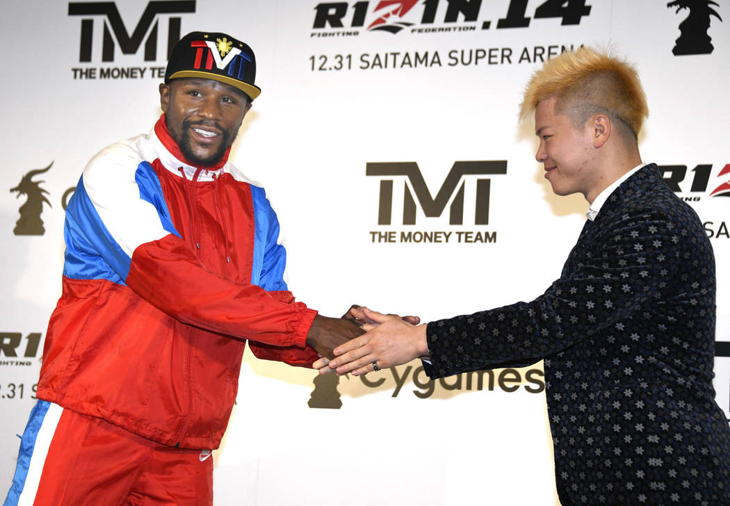 Floyd Mayweather, left, of the U.S. shakes hands with Japanese kickboxer Tenshin Nasukawa during a press conference in Tokyo, Monday, Nov. 5, 2018. Mayweather said he has signed to fight Nasukawa ...