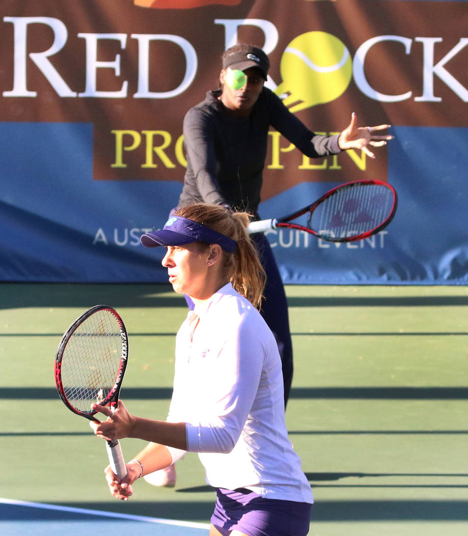 Asia Muhammad, back, returns the ball as her partner Maria Sanchez looks on as they face Manon Arcangioli and Sherazad Reix of France during their doubles match at the Red Rock Pro Open tennis tou ...
