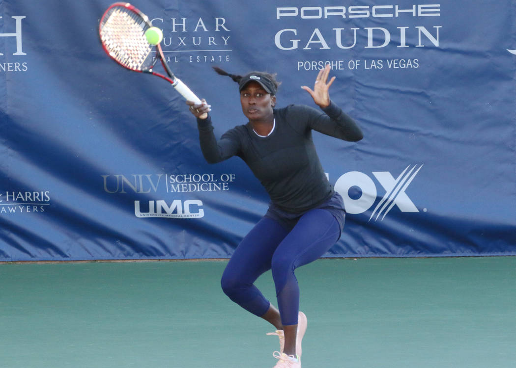 Asia Muhammad returns the ball as she and her partner Maria Sanchez face Manon Arcangioli and Sherazad Reix of France during their doubles match at the Red Rock Pro Open tennis tournament at Red R ...