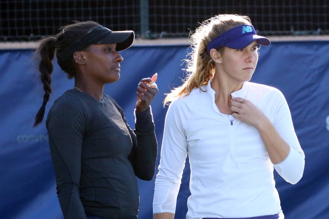 Asia Muhammad, left, and Maria Sanchez discuss as they face Manon Arcangioli and Sherazad Reix of France during their doubles match at the Red Rock Pro Open tennis tournament at Red Rock Country C ...