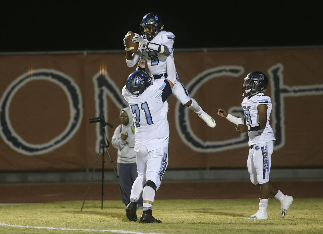 Canyon Springs' Jayvion Pugh (3) celebrates his touchdown with Canyon Springs' Trevor Moser (71) during the second half of a football game at Legacy High School in North Las Vegas on Thursday, Oct ...