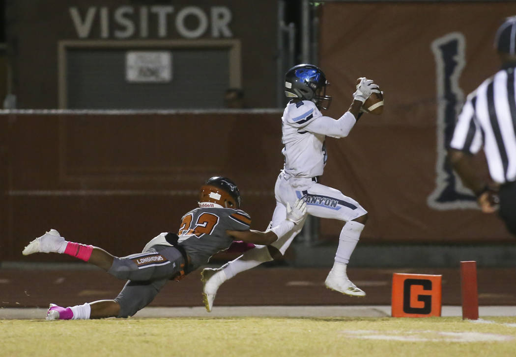 Canyon Springs Jayvion Pugh (3) runs the ball past Legacy's Mason Dailey (22) to score a touchdown during the second half of a football game at Legacy High School in North Las Vegas on Thursday, O ...