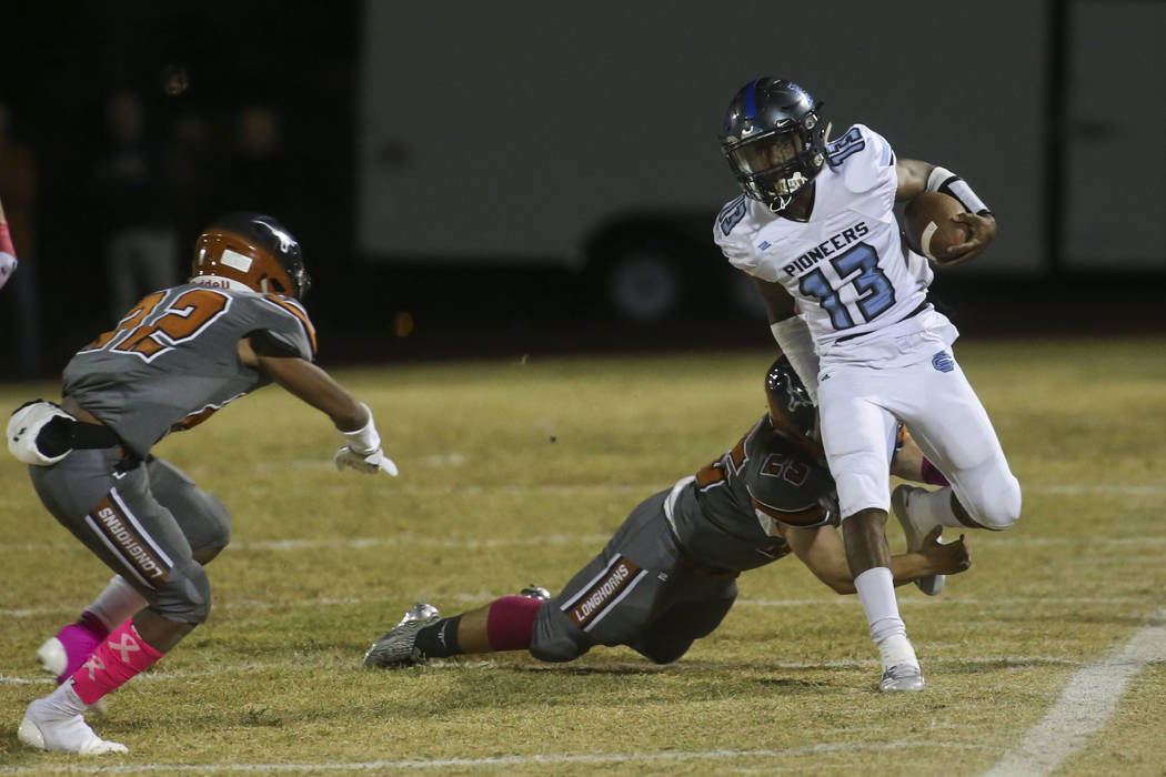 Legacy's Isaiah Sedillos (25) forces Canyon Springs' Xavier DeLong (13) out of bounds during the first half of a football game at Legacy High School in North Las Vegas on Thursday, Oct. 25, 2018. ...