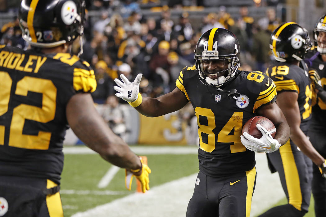 Pittsburgh Steelers wide receiver Antonio Brown celebrates his touchdown with Stevan Ridley, left, during the first half of an NFL football game against the Carolina Panthers in Pittsburgh, Thursd ...