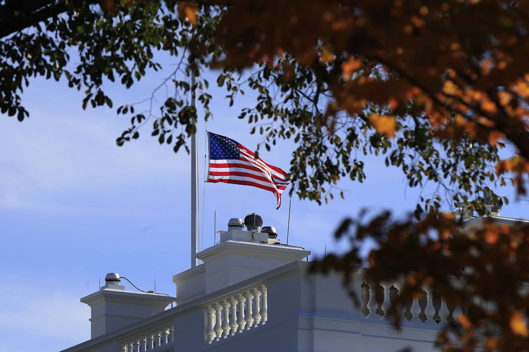 The American flag is lowered at half-staff at the White House in Washington, Thursday, Nov. 8, 2018, to honor the victims of the shooting at a bar in Thousand Oaks, Calif. A hooded former Marine o ...