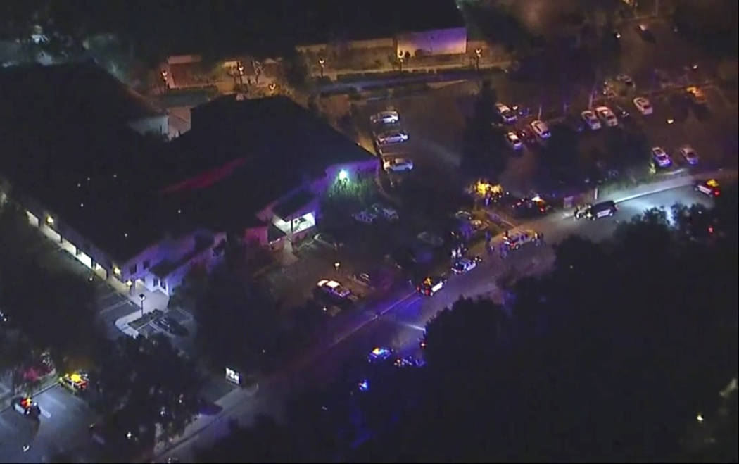 In this image made from aerial video, police vehicles line a road in the vicinity of a shooting in Thousand Oaks, California, early Thursday, Nov. 8, 2018. Authorities say there were multiple inj ...