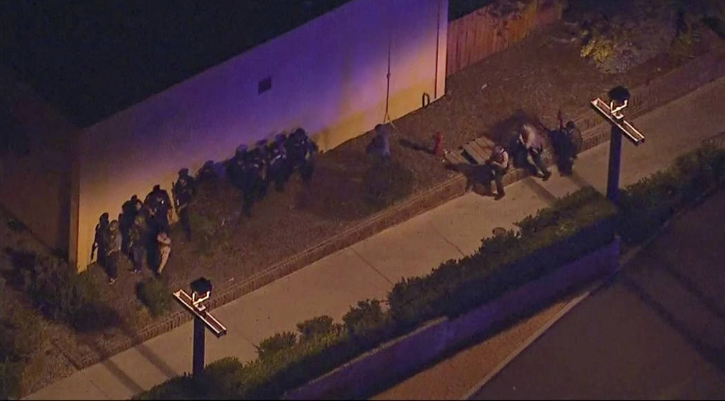 In this image made from aerial video, police move through the vicinity of a shooting in Thousand Oaks, California, early Thursday, Nov. 8, 2018. Authorities say there were multiple injuries - incl ...