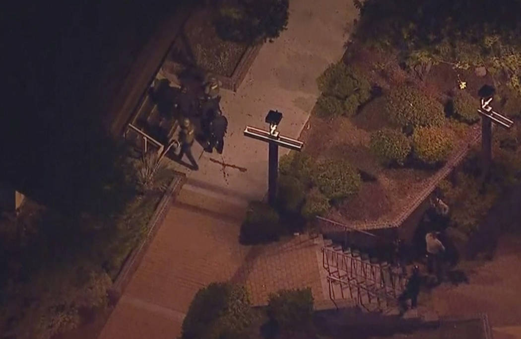 In this image made from aerial video, police move through the vicinity of a shooting in Thousand Oaks, California, early Thursday, Nov. 8, 2018. Authorities say there were multiple injuries - incl ...