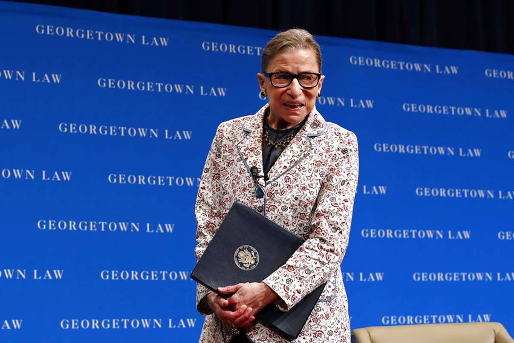 Supreme Court Justice Ruth Bader Ginsburg leaves the stage after speaking to first-year students at Georgetown Law in Washington, Sept. 26, 2018. Ginsburg has been hospitalized after fracturing th ...