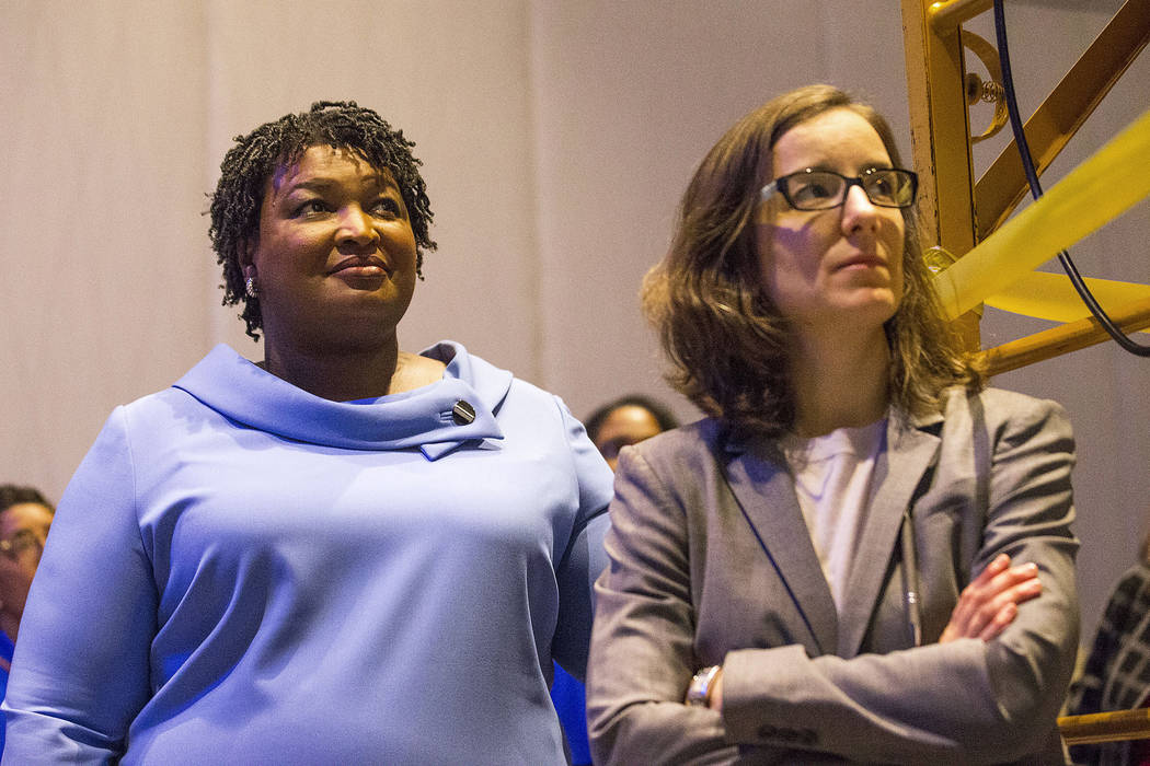Georgia gubernatorial candidate Stacey Abrams, left, stands with her campaign manager, Lauren Groh-Wargo, before speaking to her supporters during an election night watch party at the Hyatt Regenc ...