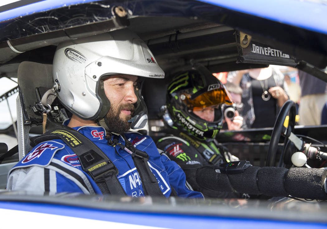 Vegas Golden Knights defenseman Deryk Engelland, left, prepares to take a ride in a race car with NASCAR driver Kurt Busch during a media event on Monday, Aug. 13, 2018, at the Las Vegas Motor Spe ...