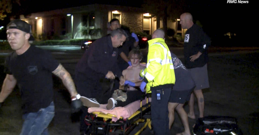 In this image taken from video a victim is treated near the scene of a shooting, Wednesday evening, Nov. 7, 2018, in Thousand Oaks, Calif. A hooded gunman dressed entirely in black opened fire on ...