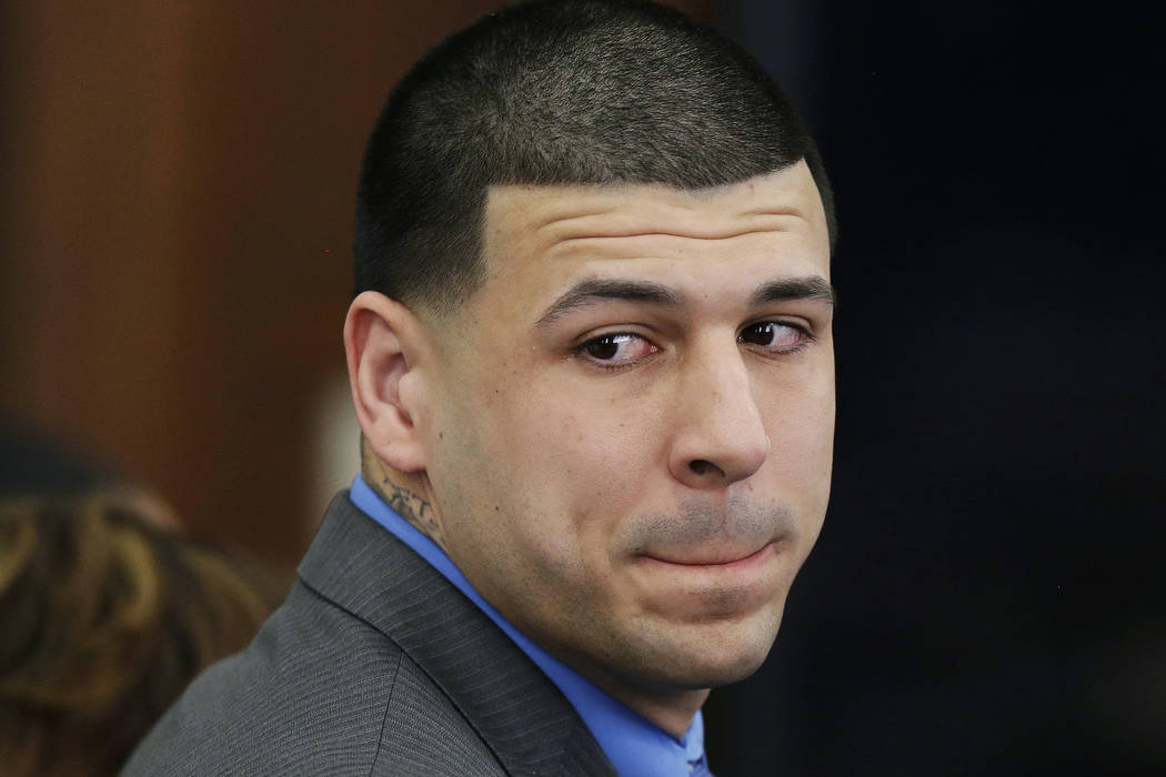 Former New England Patriots tight end Aaron Hernandez turns to look in the direction of the jury as he reacts to his double murder acquittal in the 2012 deaths of Daniel de Abreu and Safiro Furtad ...