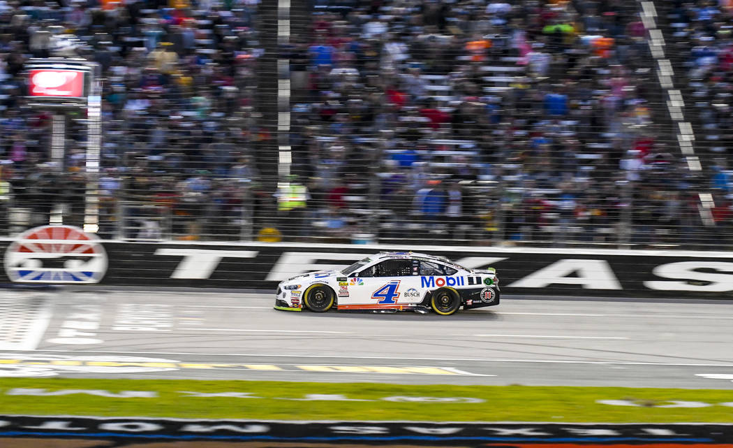 Kevin Harvick takes the checkered flag to win a NASCAR Cup auto race at Texas Motor Speedway, Sunday, Nov. 4, 2018, in Fort Worth, Texas. (AP Photo/Randy Holt)