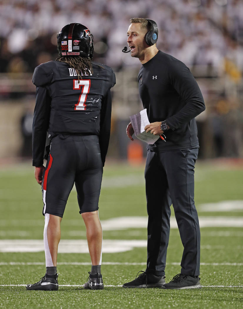 Texas Tech coach Kliff Kingsbury talks to quarterback Jett Duffey (7) during a timeout in the second half of an NCAA college football game against Oklahoma, Saturday, Nov. 3, 2018, in Lubbock, Tex ...