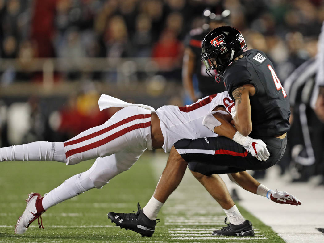 Texas Tech's Antoine Wesley (4) is tackled by Oklahoma's Robert Barnes during the second half of an NCAA college football game Saturday, Nov. 3, 2018, in Lubbock, Texas. (AP Photo/Brad Tollefson)