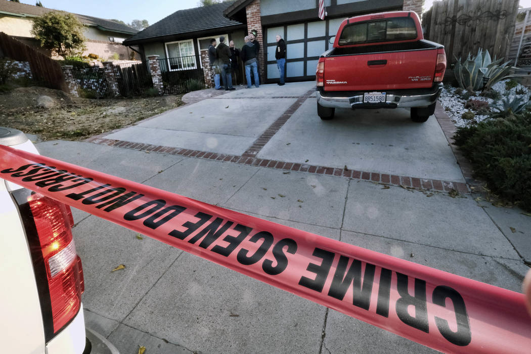 Ventura County Sheriff's deputies stand outside the house of shooting suspect David Ian Long in Newbury Park, Calif., on Thursday, Nov. 8, 2018. Authorities said the former Marine opened fire at a ...