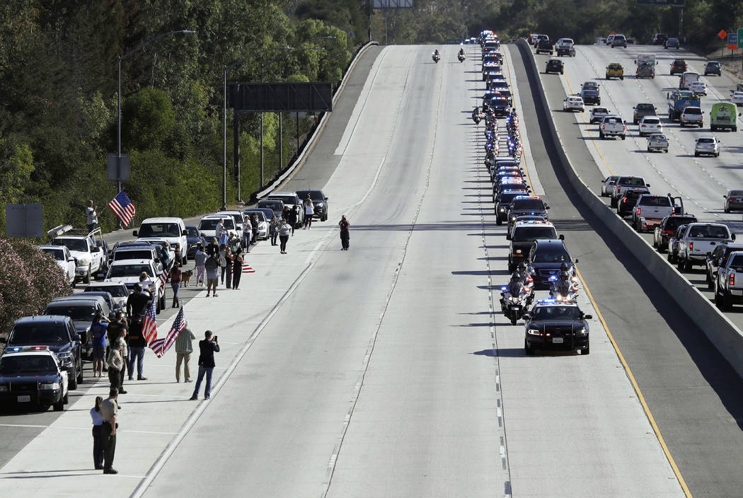 A law enforcement motorcade, providing an escort for a hearse carrying the body of Ventura County Sheriff's Sgt. Ron Helus, makes its way northbound on Highway 101 Thursday, Nov. 8, 2018, in Newbu ...