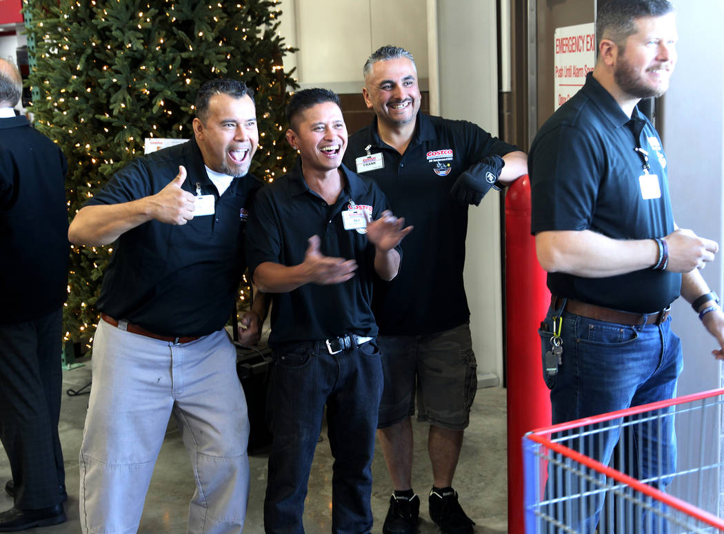 Workers, from left, Francisco Lorenzo, Ali Padilla, Frank Valdez and Bradley Balfour welcome the first customers at the grand opening of Costco near the intersection of St. Rose Parkway and Amigo ...