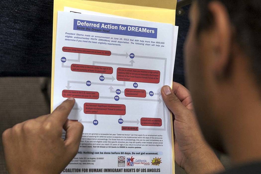 A legal immigrant reads a guide of the conditions needed to apply for Obama-era Deferred Action for Childhood Arrivals (DACA) program at the Coalition for Humane Immigrant Rights, CHIRLA offices i ...