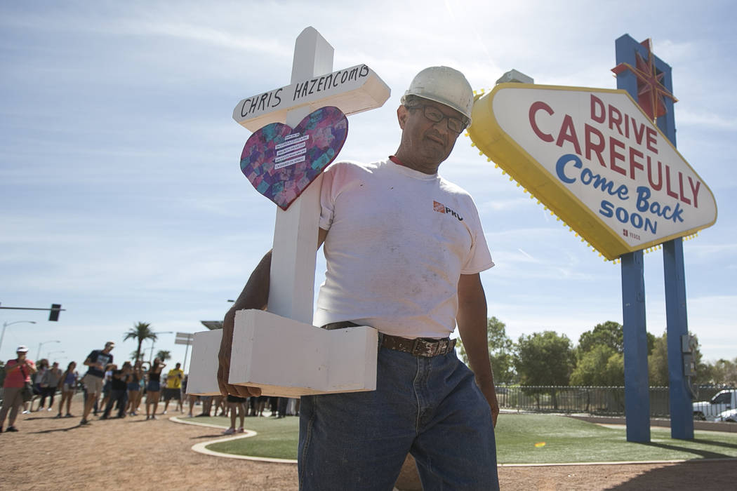 Greg Zanis, of Aurora, Ill., carries one of 58 crosses he placed near the Welcome to Fabulous Las Vegas sign honoring victims of the Oct.1 shooting on Friday, Sept. 28, 2018. Richard Brian Las Veg ...