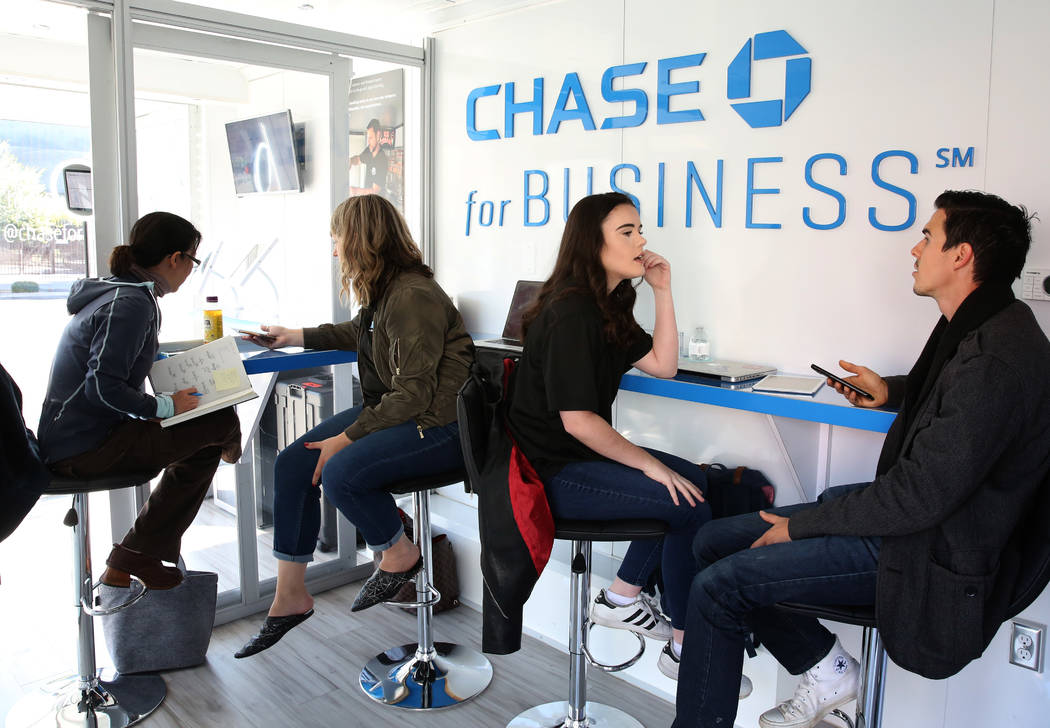 Brooklynne Peters, second left, creative director at Zen Media and Melanie Majors, community coordinator, second right, discuss with Irene Chiu, left, founder of small businesses, and Chase Spillm ...
