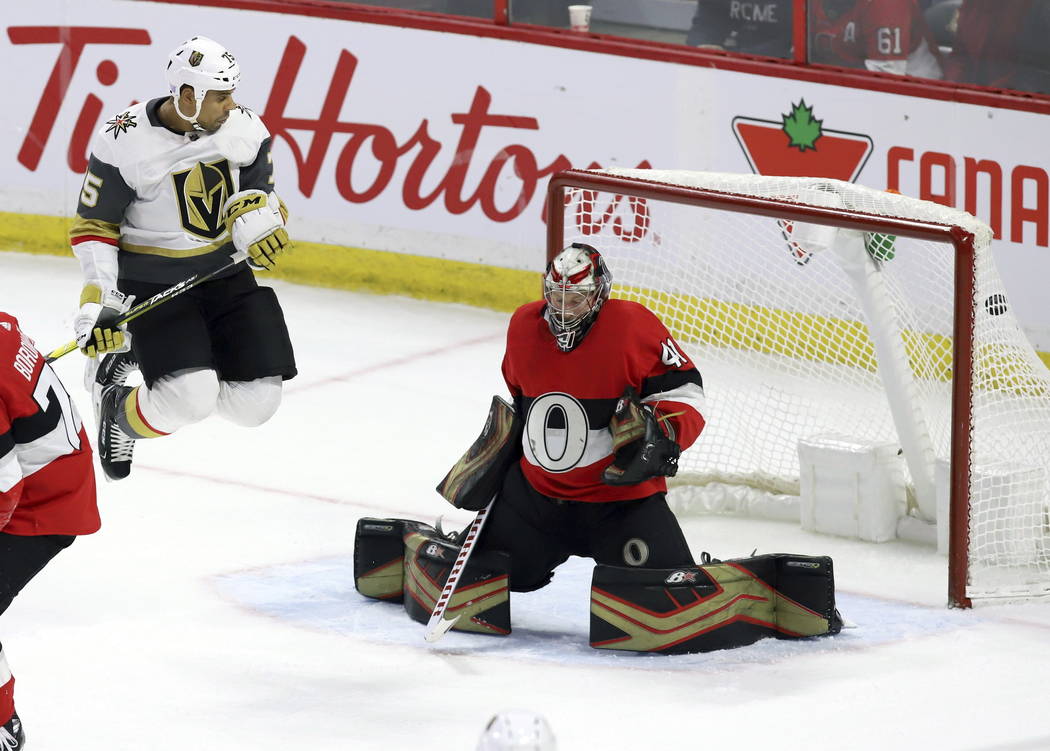 The puck gets past Ottawa Senators goaltender Craig Anderson (41) as he is screened by Vegas Golden Knights right wing Ryan Reaves (75) on a shot by Vegas Golden Knights defenseman Shea Theodore, ...