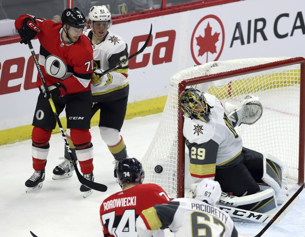 Ottawa Senators center Chris Tierney (71) and Vegas Golden Knights center Cody Eakin (21) look on as Vegas Golden Knights goaltender Marc-Andre Fleury (29) covers the side of the net during the fi ...
