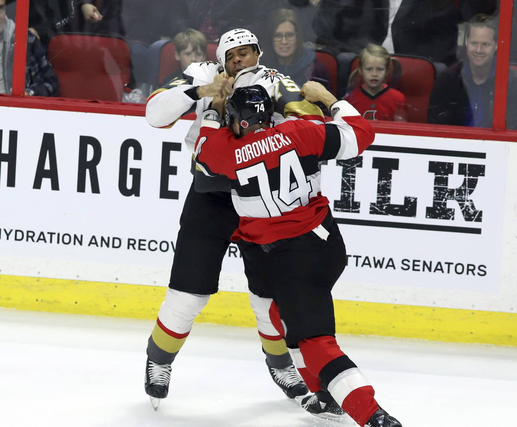 Ottawa Senators defenceman Mark Borowiecki (74) and Vegas Golden Knights right wing Ryan Reaves (75) fight during the second period of an NHL hockey game, Wednesday, Nov. 8, 2018 in Ottawa, Ontari ...