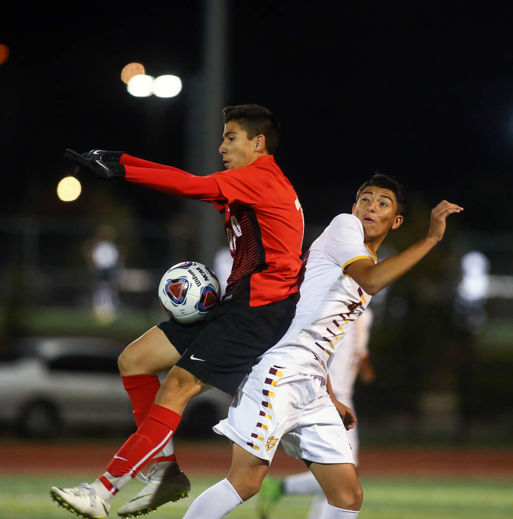 Coronado's Diaz Alfredo (13) traps the ball while under pressure from Eldorado's Alejandro Plaza (4) during the state quarterfinal game at Faith Lutheran High School in Las Vegas, Thursday,Nov. 8, ...