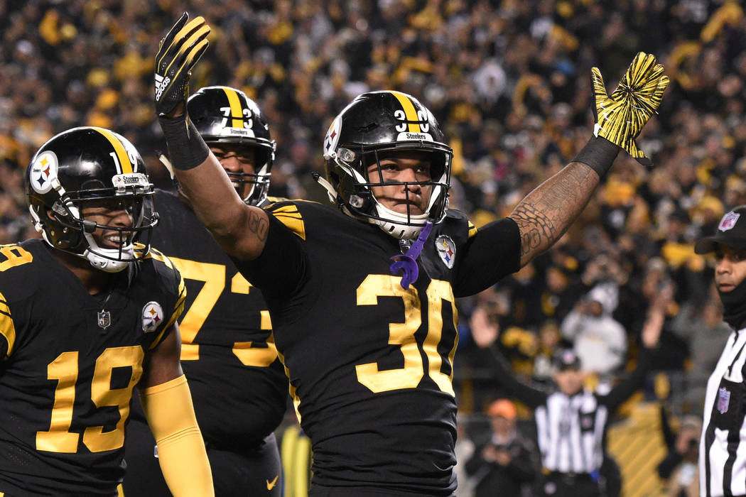 Pittsburgh Steelers running back James Conner (30) celebrates his touchdown against the Carolina Panthers during the first half of an NFL football game in Pittsburgh, Thursday, Nov. 8, 2018. (AP P ...