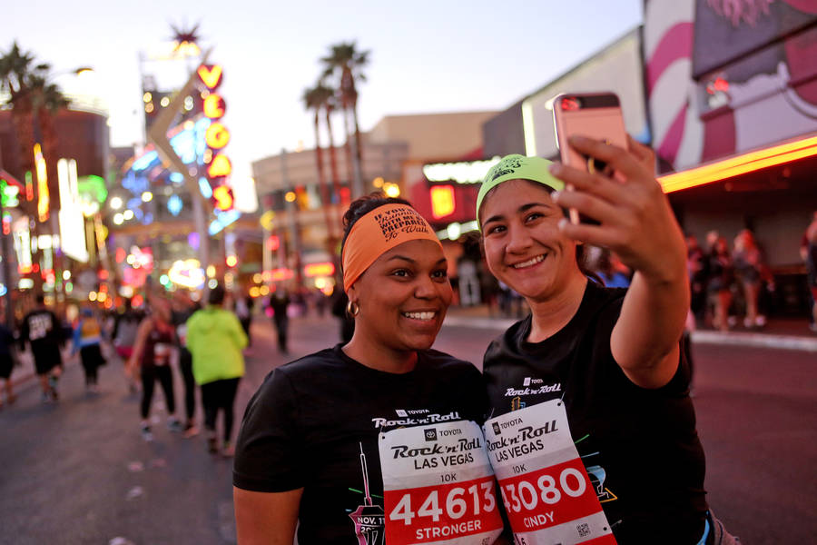 Jessica Fred, left, from Los Angeles, takes a selfie with Cindy Loza, from Long Beach, during the 10k race on Fremont Street for the Rock 'n' Roll Marathon in Las Vegas, Sunday, Nov. 11, 2018. Rac ...