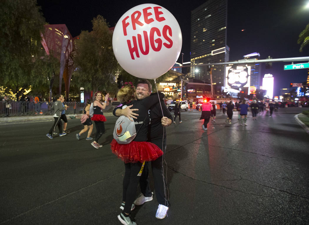 Marty Beckers of Henderson gives out free hugs to passing runners during the 2018 Rock 'n' Roll Marathon on the Strip in Las Vegas on Sunday, Nov. 11, 2018. Beckers hugged over 1400 participants. ...