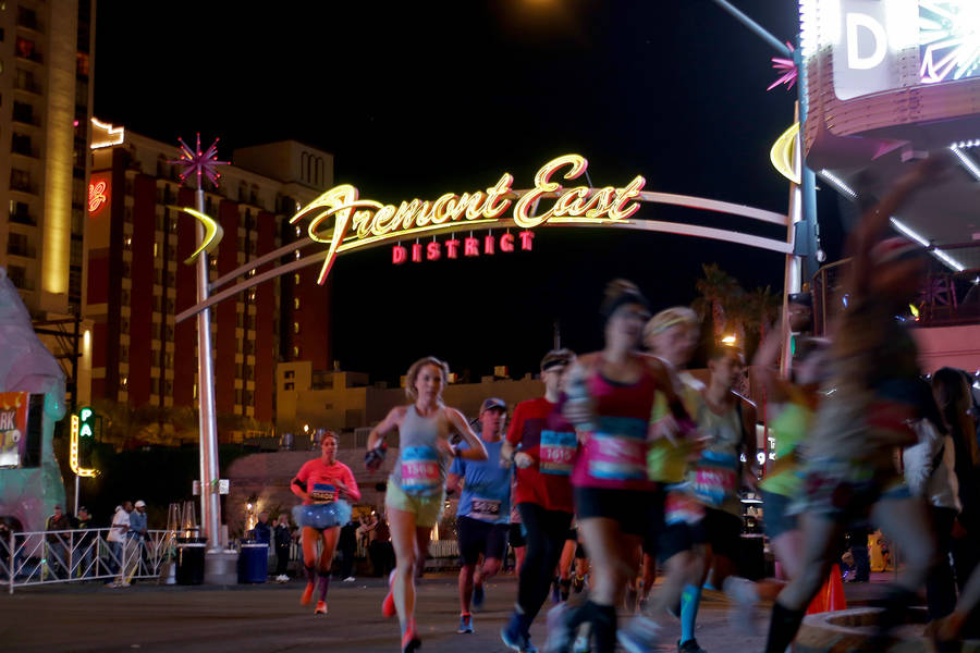 Runners in the marathon and half marathon race run the corner of Fremont Street and Las Vegas Boulevard for the Rock 'n' Roll Marathon in Las Vegas, Sunday, Nov. 11, 2018. Rachel Aston Las Vegas R ...