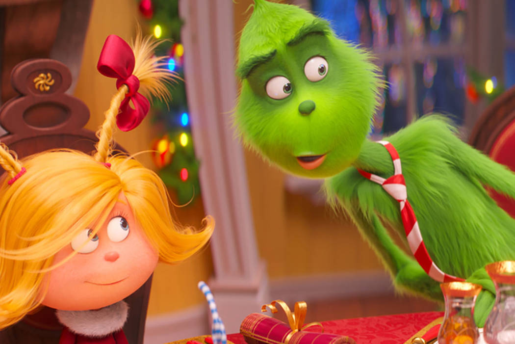 Cindy-Lou Who, voiced by Cameron Seely, left, and Grinch, voiced by Benedict Cumberbatch, are seen in a scene from "The Grinch." (Universal Pictures via AP, File)