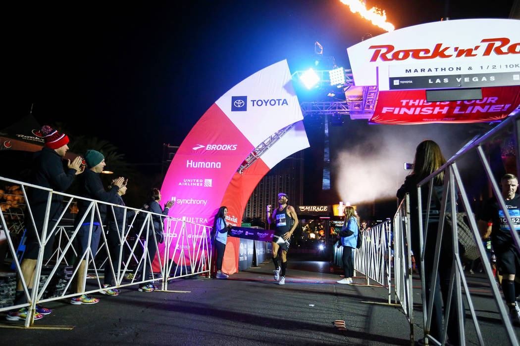 First place finisher Thomas Puzey crosses the finish line with a time of during the 2018 Rock 'n' Roll Marathon on the Strip in Las Vegas, Sunday,Nov. 11, 2018. Caroline Brehman/Las Vegas Review-J ...