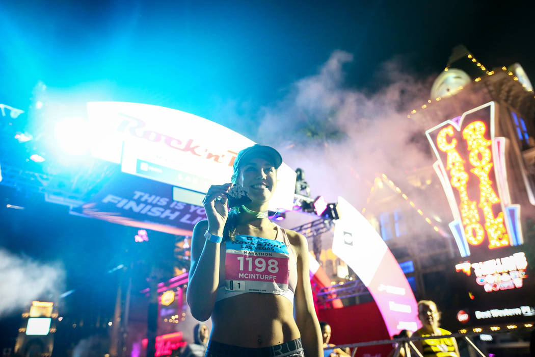First place women's finisher Hannah McInturff poses with her medal in front of the finish line during the 2018 Rock 'n' Roll Marathon on the Strip in Las Vegas, Sunday,Nov. 11, 2018. Caroline Breh ...
