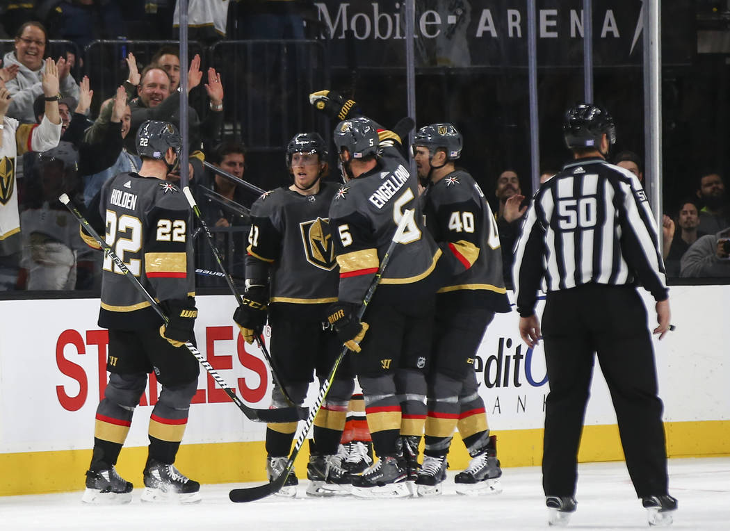 Golden Knights players celebrate the second goal by Golden Knights center Cody Eakin, second from left, during the second period of an NHL hockey game against the Anaheim Ducks at T-Mobile Arena i ...