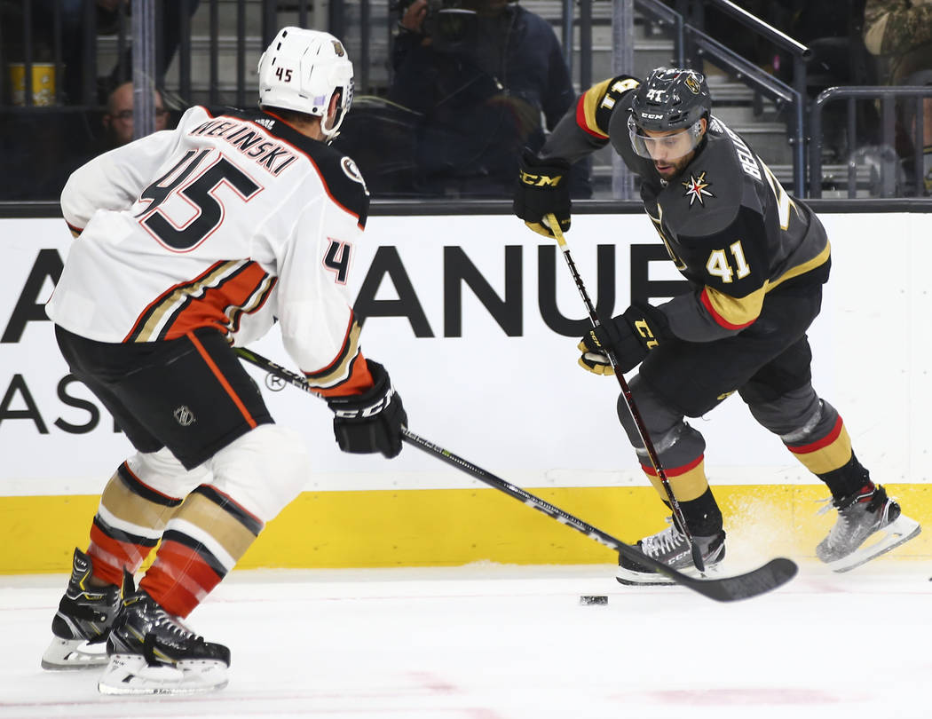 Golden Knights center Pierre-Edouard Bellemare (41) looks to send the puck past Anaheim Ducks defenseman Andy Welinski (45) during the first period of an NHL hockey game at T-Mobile Arena in Las V ...