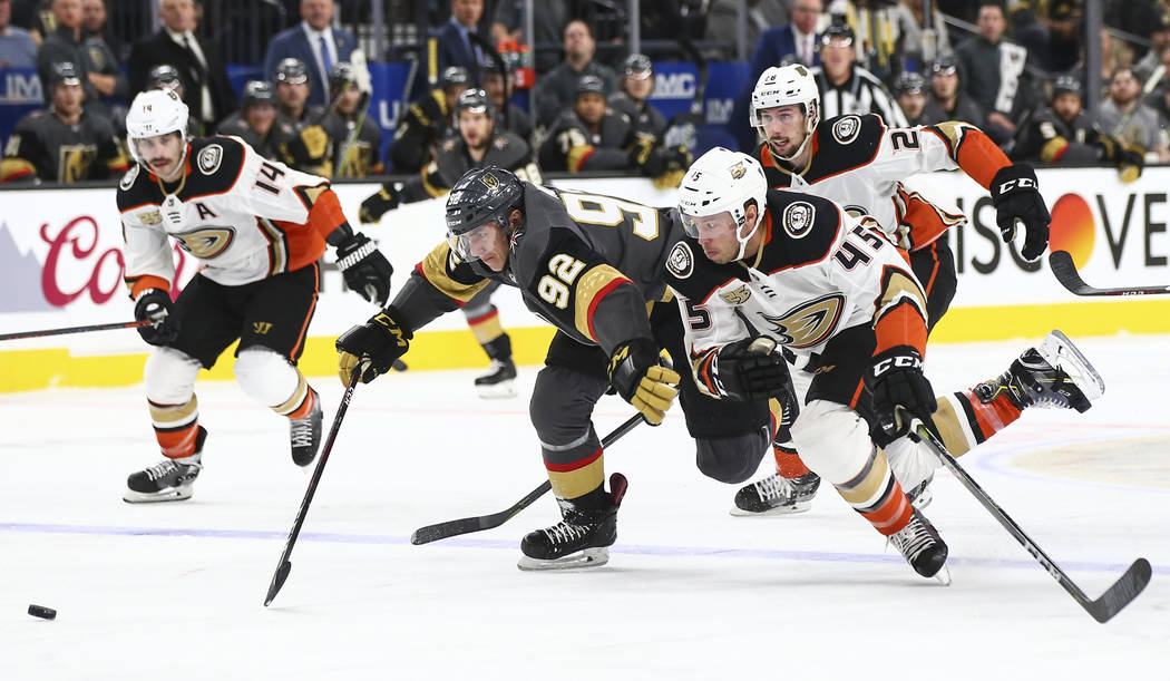 Golden Knights left wing Tomas Nosek (92) and Anaheim Ducks defenseman Andy Welinski (45) chase after the puck during the first period of an NHL hockey game at T-Mobile Arena in Las Vegas on Wedne ...