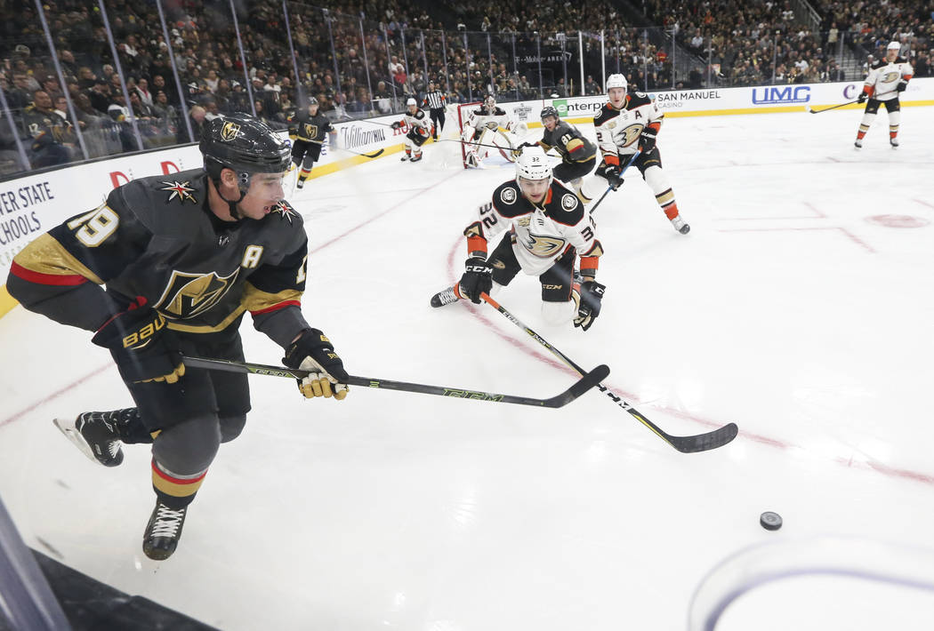 Golden Knights right wing Reilly Smith (19) and Anaheim Ducks defenseman Jacob Larsson (32) go after the puck during the first period of an NHL hockey game at T-Mobile Arena in Las Vegas on Wednes ...