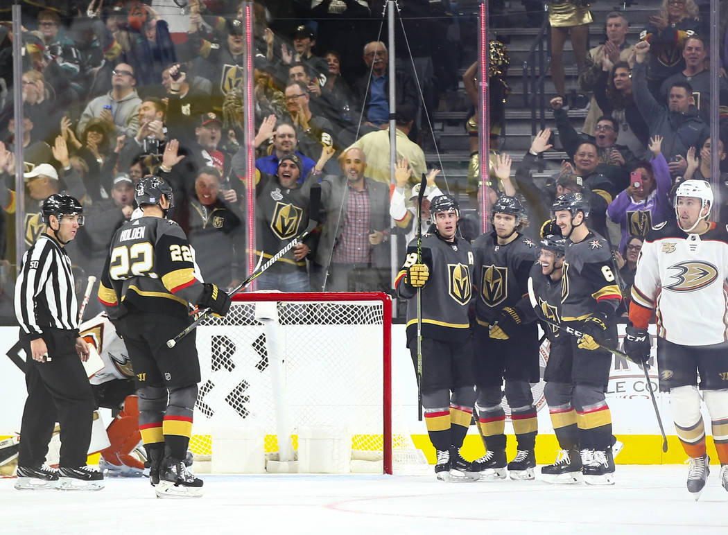 Golden Knights players celebrate a goal by Golden Knights defenseman Nick Holden (22) during the second period of an NHL hockey game against the Anaheim Ducks at T-Mobile Arena in Las Vegas on Wed ...